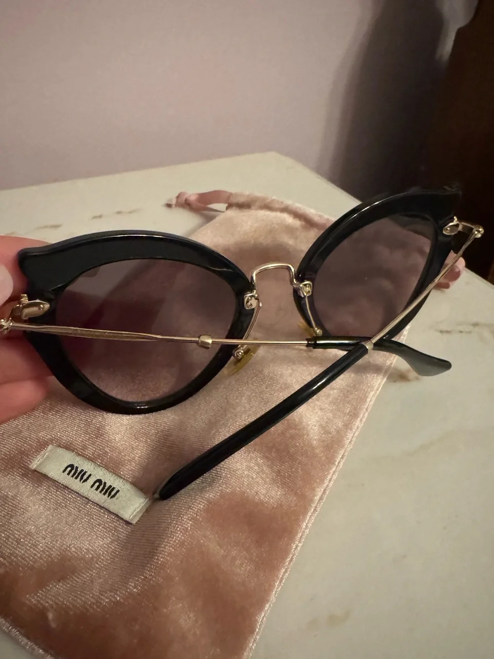 Miu Miu Black Cat-Eye Sunglasses with Gold Accents